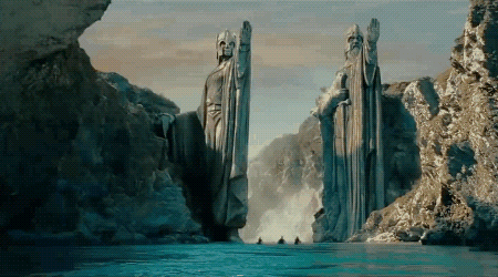 A river running through two big statues carved out of stone