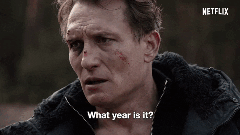 A man with several cuts on his face asks a mother in a red dress and her son: "What year is it?"